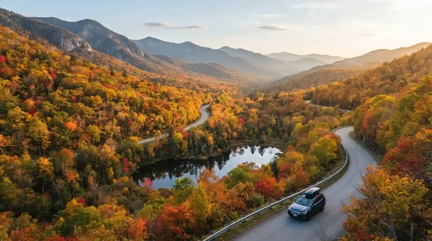 Scenic American mountain landscape with colorful autumn foliage and a winding road