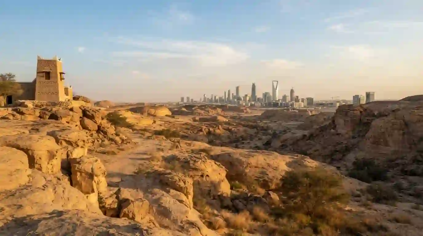 Saudi Arabian desert landscape with modern city architecture in the distance