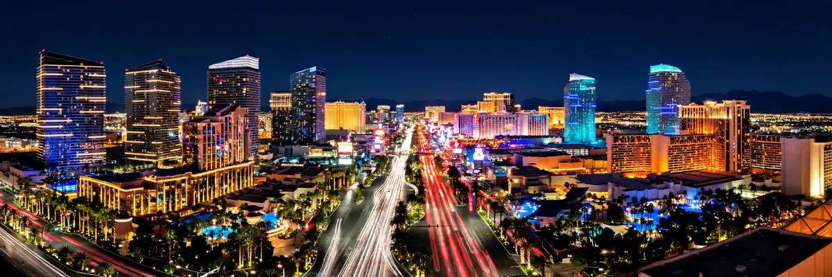 Las Vegas on a budget – the illuminated Las Vegas Strip at night with glowing casino towers and light trails